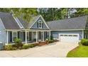 Charming home featuring blue siding, white trim, and a spacious driveway at 3180 Long Avenue Ext., Conway, SC 29526