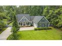 Aerial view of the home showcasing its charming facade and lush surrounding greenery at 3180 Long Avenue Ext., Conway, SC 29526