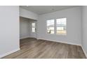 The living room features wood flooring, white walls, and a bright front door at 335 Garden Grove St, Conway, SC 29526