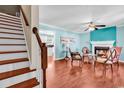 Inviting living room featuring beautiful hardwood floors and a cozy fireplace at 340 Boxcar Dr., Longs, SC 29568