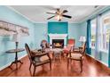 Inviting living room featuring beautiful hardwood floors and a cozy fireplace at 340 Boxcar Dr., Longs, SC 29568