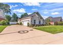 Spacious driveway leading to a two-car garage with well-maintained landscaping at 3736 Kingsley Dr., Myrtle Beach, SC 29588