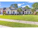 Charming white brick home with lush green lawn and well-maintained landscaping at 3736 Kingsley Dr., Myrtle Beach, SC 29588