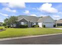 Charming single-story home featuring a well-manicured lawn, brick accents, and an attached two-car garage at 4012 Grousewood Dr., Myrtle Beach, SC 29588