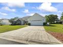 Shot of home with lush lawn, brick accents, two-car garage, and long driveway leading up to the house at 4012 Grousewood Dr., Myrtle Beach, SC 29588