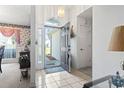 Bright and inviting foyer with tile flooring, decorative glass door, and elegant chandelier at 4012 Grousewood Dr., Myrtle Beach, SC 29588