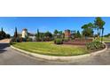 A beautiful entrance to Waterbridge features lush landscaping, a decorative fountain, and a brick monument sign at 419 Starlit Way, Myrtle Beach, SC 29579
