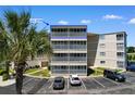 Exterior showcasing the top condo unit with screened-in porch and parking at 4350 Intercoastal Dr. # 2408, Little River, SC 29566