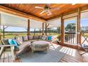 Inviting covered porch with comfortable seating, stylish rug and wooded views at 4499 Highway 308, Aynor, SC 29544