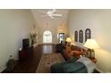 Bright living room with vaulted ceiling, hardwood floors, and large windows at 513 Westham Dr., Murrells Inlet, SC 29576