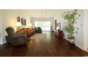 Cozy living room featuring hardwood floors, a ceiling fan, and large windows at 513 Westham Dr., Murrells Inlet, SC 29576