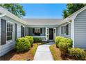 Inviting front entrance with a walkway, landscaped bushes and a welcoming black front door at 578 Circle Dr., Myrtle Beach, SC 29575