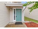 Inviting front entrance featuring a bright teal door, neutral siding, and a well-maintained exterior at 600 Deer Creek Rd. # D, Surfside Beach, SC 29575