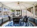 Charming screened-in gazebo featuring a round table, seating for six, and an overhead ceiling fan at 6001 - 1842 S Kings Hwy., Myrtle Beach, SC 29575