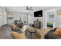 Comfortable living room with stylish furniture, a ceiling fan, and a glimpse into the cozy bedroom at 6001-1643 S Kings Hwy., Myrtle Beach, SC 29575