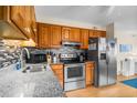 This spacious kitchen features stainless steel appliances, tile backsplash, and granite countertops at 6309 N Ocean Blvd. # 14 E, North Myrtle Beach, SC 29582