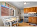 Kitchen with a view of the house next door, stainless steel appliances, and light wooden cabinets at 6309 N Ocean Blvd. # 14 E, North Myrtle Beach, SC 29582