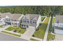 Aerial view of a two-story home with a spacious backyard and a well-manicured front lawn at 8076 Fort Hill Way, Myrtle Beach, SC 29579