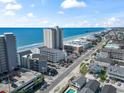 Aerial view of an oceanfront community with multiple buildings, swimming pools, and views of the ocean at 920 N Waccamaw Dr. # 2102, Murrells Inlet, SC 29576