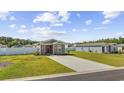 Wide angle view of a single-story home with landscaped yard, long concrete driveway and white fence at 924 Akron St., Conway, SC 29526