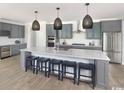 Modern kitchen with stainless steel appliances, ample counter space, and a large island at 9419 Long Meadow Way, Longs, SC 29568