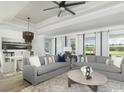 Bright, open living space with elegant furnishings, ceiling fan, and natural light at 9419 Long Meadow Way, Longs, SC 29568