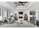 Stylish living room featuring fireplace, coffered ceilings and adjacent wet bar at 9419 Long Meadow Way, Longs, SC 29568