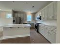 Stylish kitchen features white cabinets, an island and stainless steel appliances at 1000 Lady Bird Way, North Myrtle Beach, SC 29582