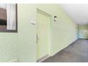Hallway view that leads to unit 110, complimented with a neutral colored walls and carpeted floors at 1105 S Ocean Blvd. # 110, Myrtle Beach, SC 29577