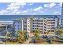 Low rise condo building featuring well manicured landscaping and beach access at 1310 N Waccamaw Dr. # 208, Garden City Beach, SC 29576