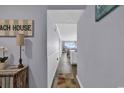 Inviting hallway leads to a cozy living space with ocean views in this beachside condo at 1310 N Waccamaw Dr. # 208, Garden City Beach, SC 29576