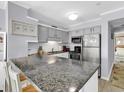 Modern kitchen featuring granite countertops, and stainless steel appliances at 1310 N Waccamaw Dr. # 208, Garden City Beach, SC 29576