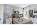 Comfortable bedroom with light blue and white paint, side tables, and calming decor at 143 Warner Crossing Way, Loris, SC 29569