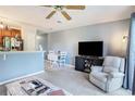 Inviting open-plan living area with a tv, chair, and small dining table near the open bar and kitchen at 1460 Blue Tree Ct. # E, Myrtle Beach, SC 29588