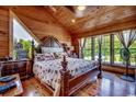 Cozy wood paneled primary bedroom with a large windows offering serene views of the outdoors at 181 Halfway Rd., Nichols, SC 29581