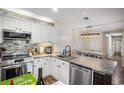 Modern kitchen with stainless steel appliances, granite countertops, and stylish backsplash at 19 Pistachio Loop # F, Murrells Inlet, SC 29576