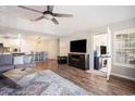Open-concept living room with hardwood floors, modern furnishings, and lots of natural light at 19 Pistachio Loop # F, Murrells Inlet, SC 29576