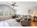 Bright living room with vaulted ceilings, large windows, and a stylish rug at 19 Pistachio Loop # F, Murrells Inlet, SC 29576
