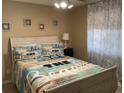 Cozy bedroom featuring beach-themed decor, a queen bed, and light-filtering curtains at 1900 Duffy St. # L-5, North Myrtle Beach, SC 29582