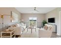 Bright living room with a neutral color palette and sliding doors to the backyard at 208 Warner Crossing Way, Loris, SC 29569