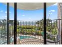 Balcony overlooking the beach with a view of a pool, palm trees, and blue skies at 2500 N Ocean Blvd. # 102, Myrtle Beach, SC 29577