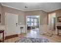Elegant entryway with wood-look floors, wainscoting, and views into the adjacent living spaces at 251 Copper Leaf Dr., Myrtle Beach, SC 29588