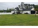 Beautiful home features a well-manicured lawn and a white fence, which provides a sense of privacy and security at 2529 Suzanne Dr., Conway, SC 29526