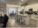 Bright eat-in kitchen with white cabinets, stainless steel appliances, granite countertops, and island seating at 2529 Suzanne Dr., Conway, SC 29526