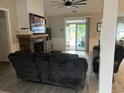 Relaxing living room with a stone fireplace, a large sliding glass door, and neutral wall color at 2529 Suzanne Dr., Conway, SC 29526