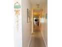Hallway with light pink walls, carpeted floors, and starfish decor, leading to the living area at 305 N Hillside Dr. # 206, North Myrtle Beach, SC 29582