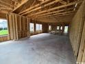 The new home interior has concrete flooring and framed walls ready to be finished at 3072 Palma Way, Myrtle Beach, SC 29579