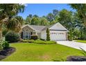 Well-maintained one-story home featuring a lush lawn and attached two-car garage at 4 Clemson Rd., Conway, SC 29526