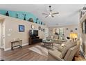 Spacious living room with vaulted ceiling, modern fan, and comfortable furnishings at 4 Clemson Rd., Conway, SC 29526