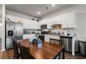 Bright kitchen featuring granite countertops, stainless steel appliances, and wooden dining table with seating at 402 Toledo St., Conway, SC 29526
